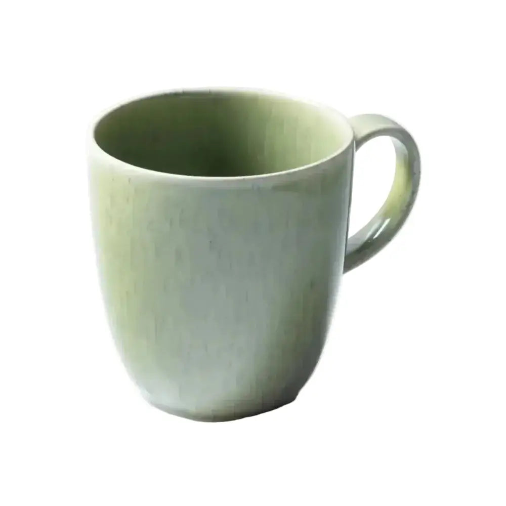 Green ceramic mug on a white background