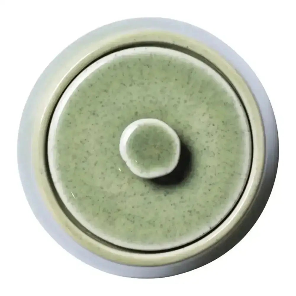Round ceramic dish with a textured surface on a white background