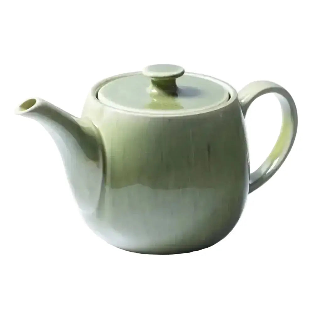 Green ceramic teapot on a white background