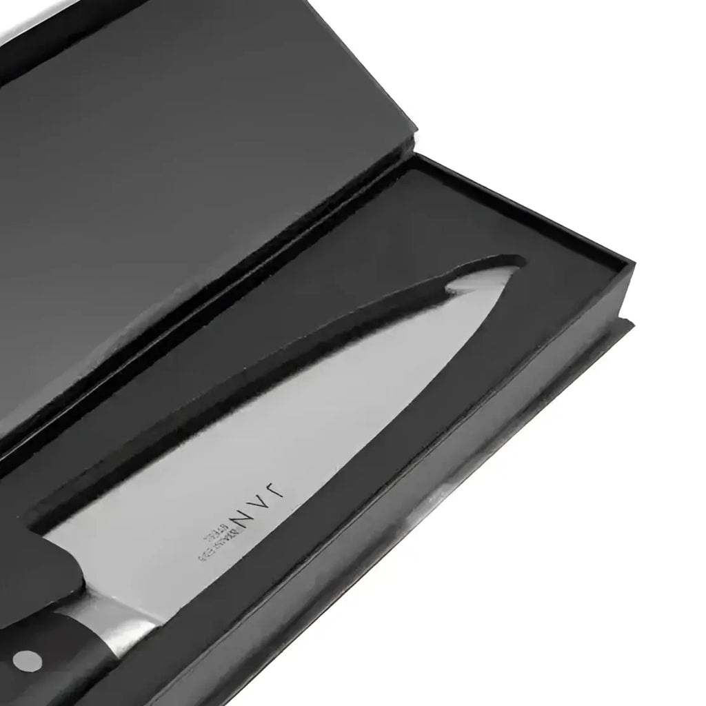 Knife with black handle and blade in a black box on a white background