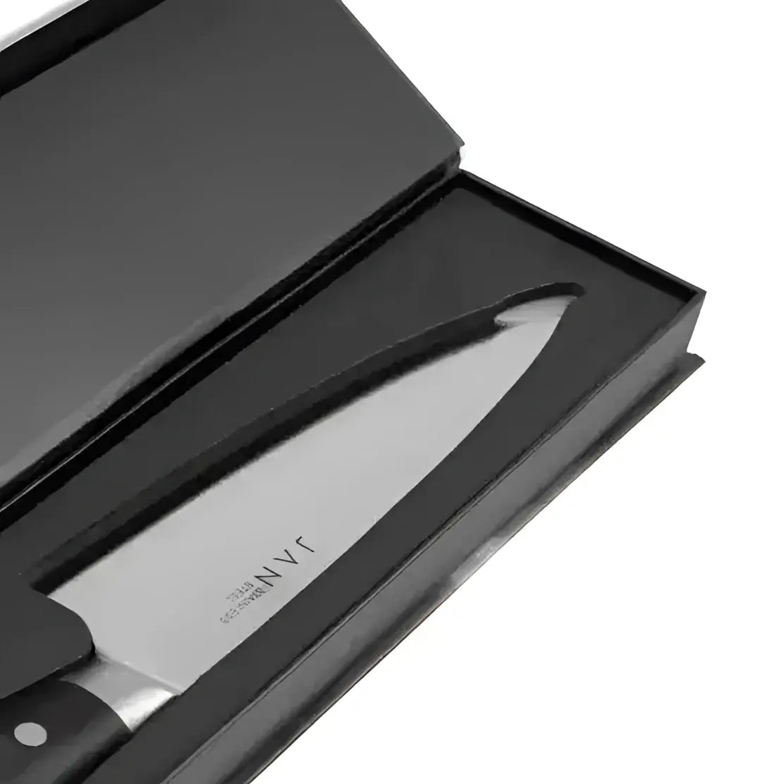 Knife with black handle and blade in a black box on a white background