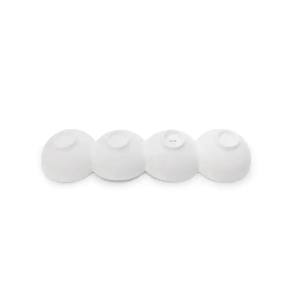 Four white spherical objects on a white background
