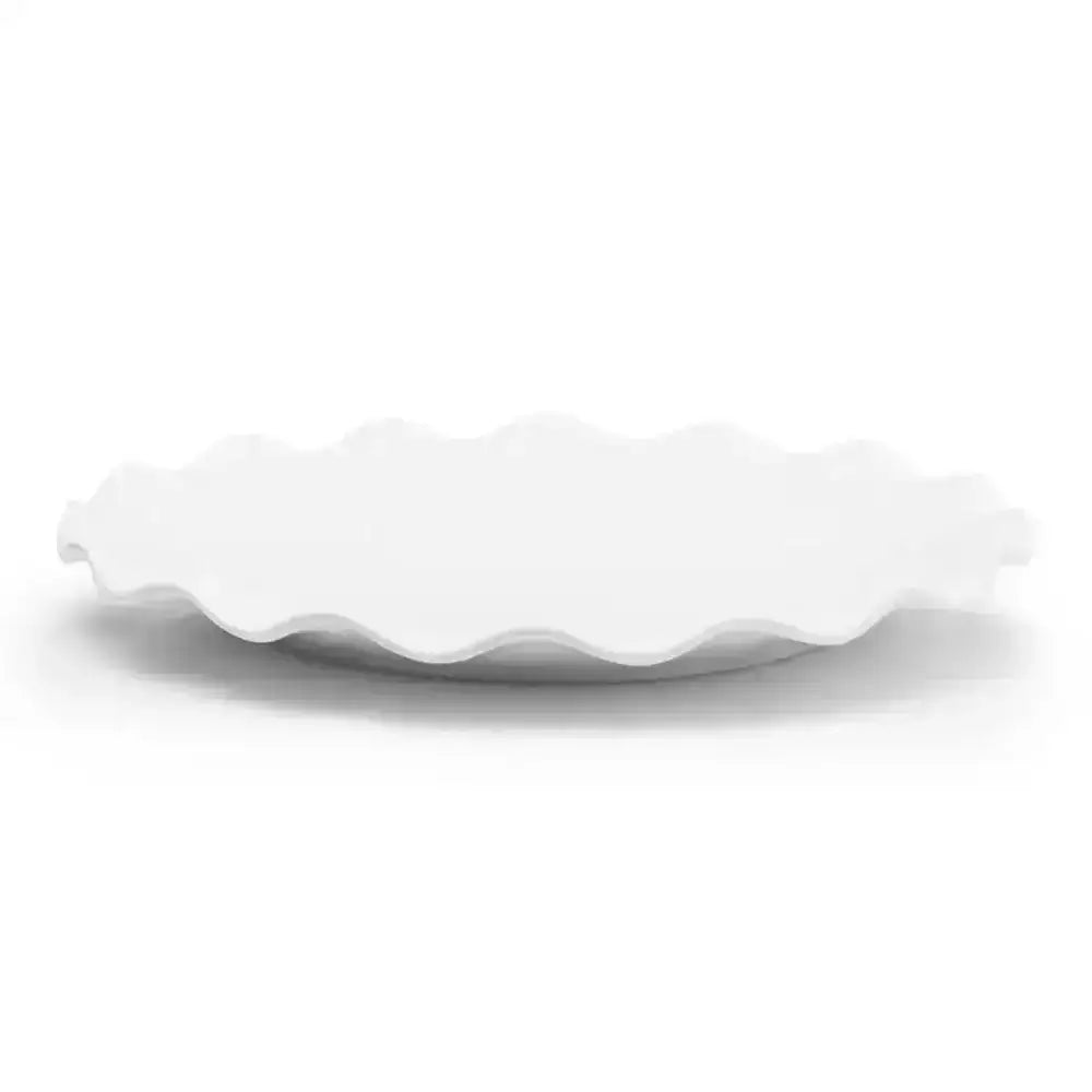 White ceramic plate with wavy edge on a white background