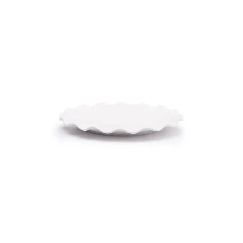 White scalloped-edge side plate on a white background