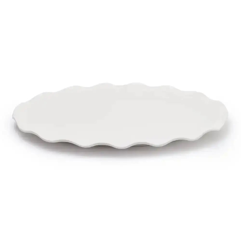 White scalloped-edge ceramic platter on a white background