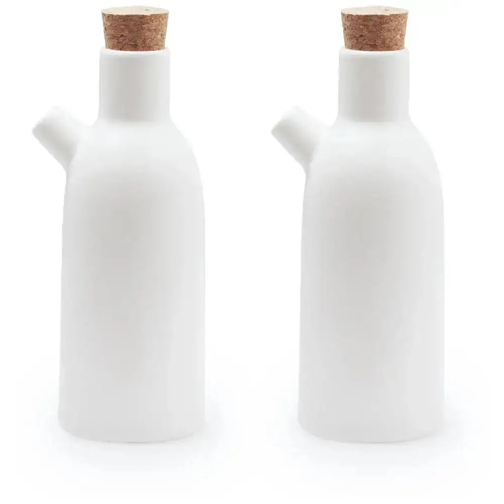 Two white ceramic bottles with cork lids on a white background