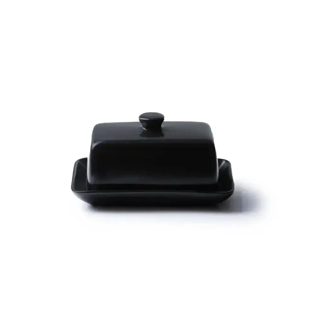 Black butter dish with lid on a white background