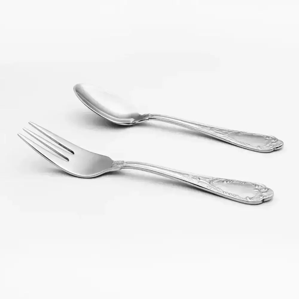 Silver cake fork and teaspoon on a white background