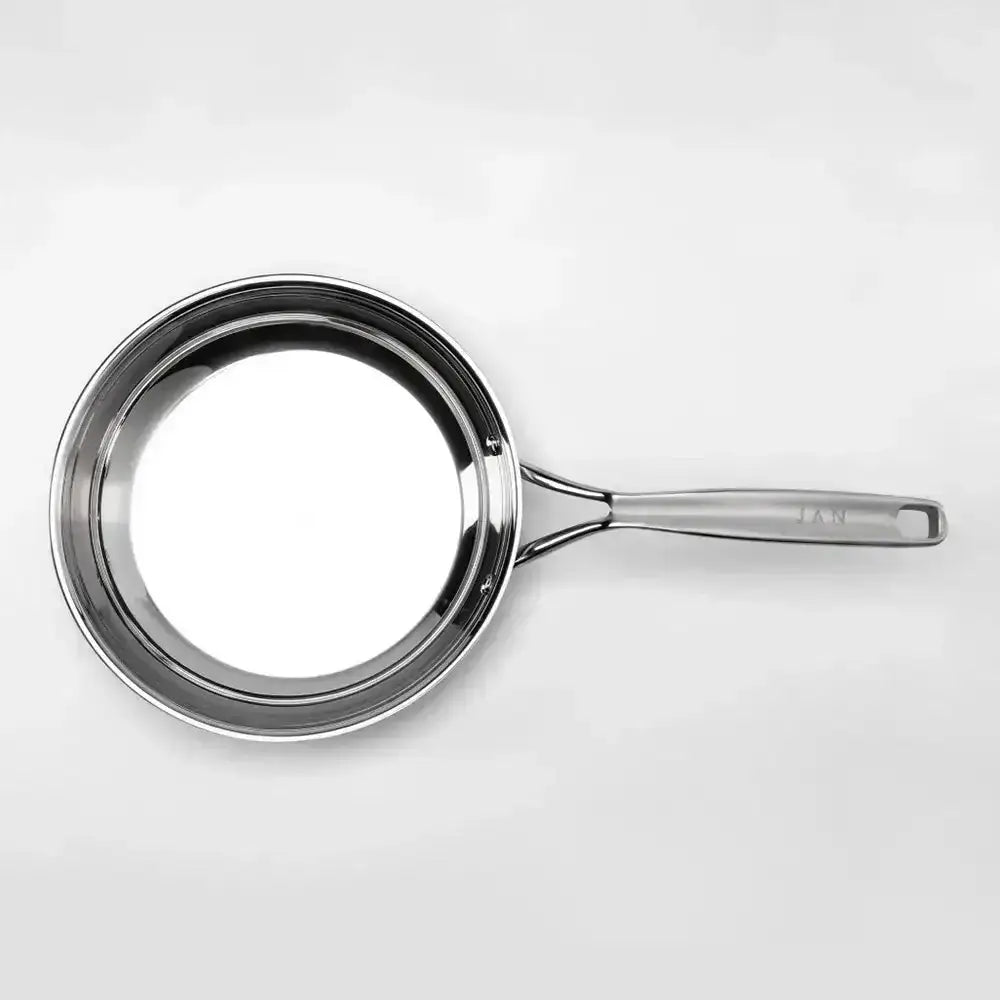 Stainless steel frying pan on a white background