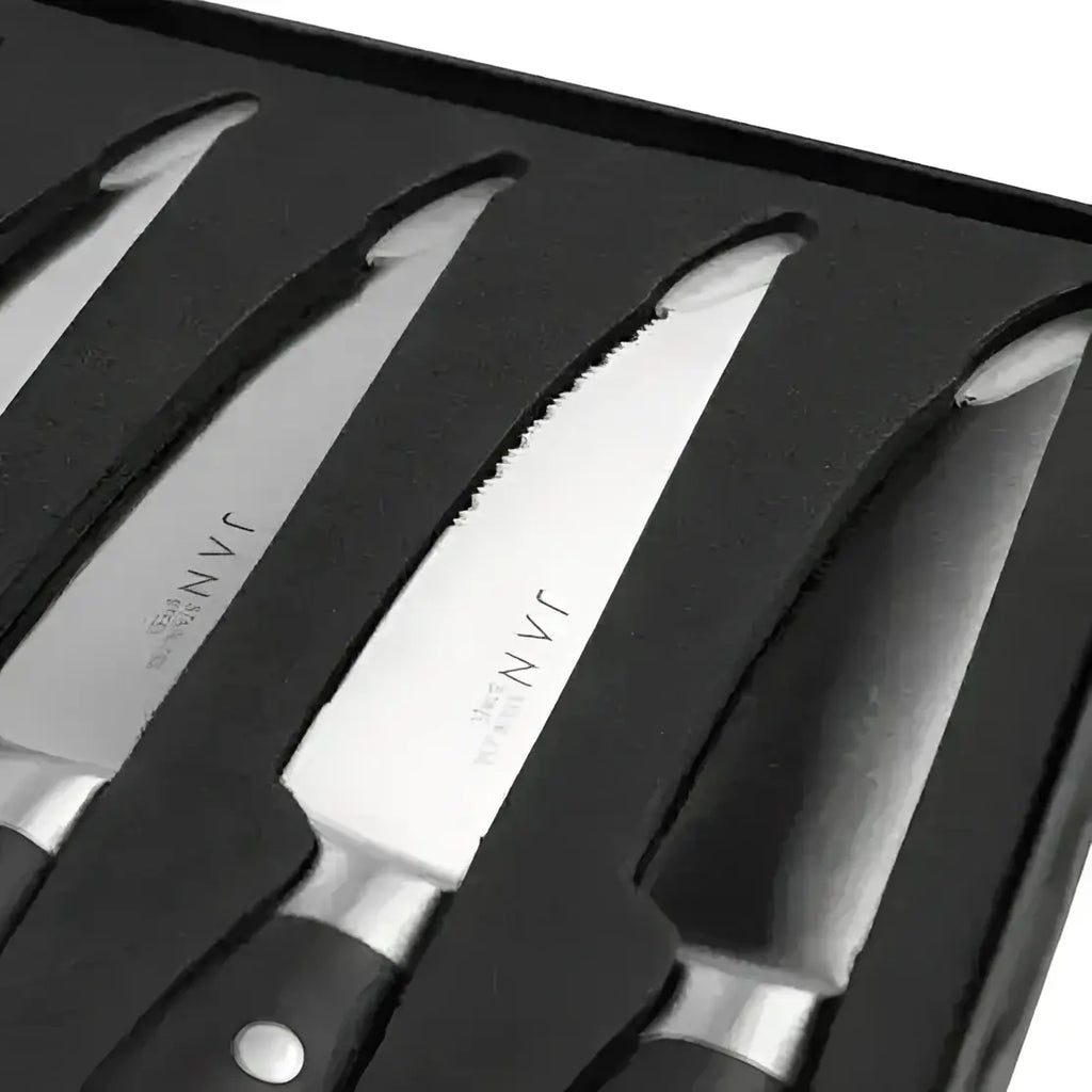 Set of steak knives with black handles in a black box