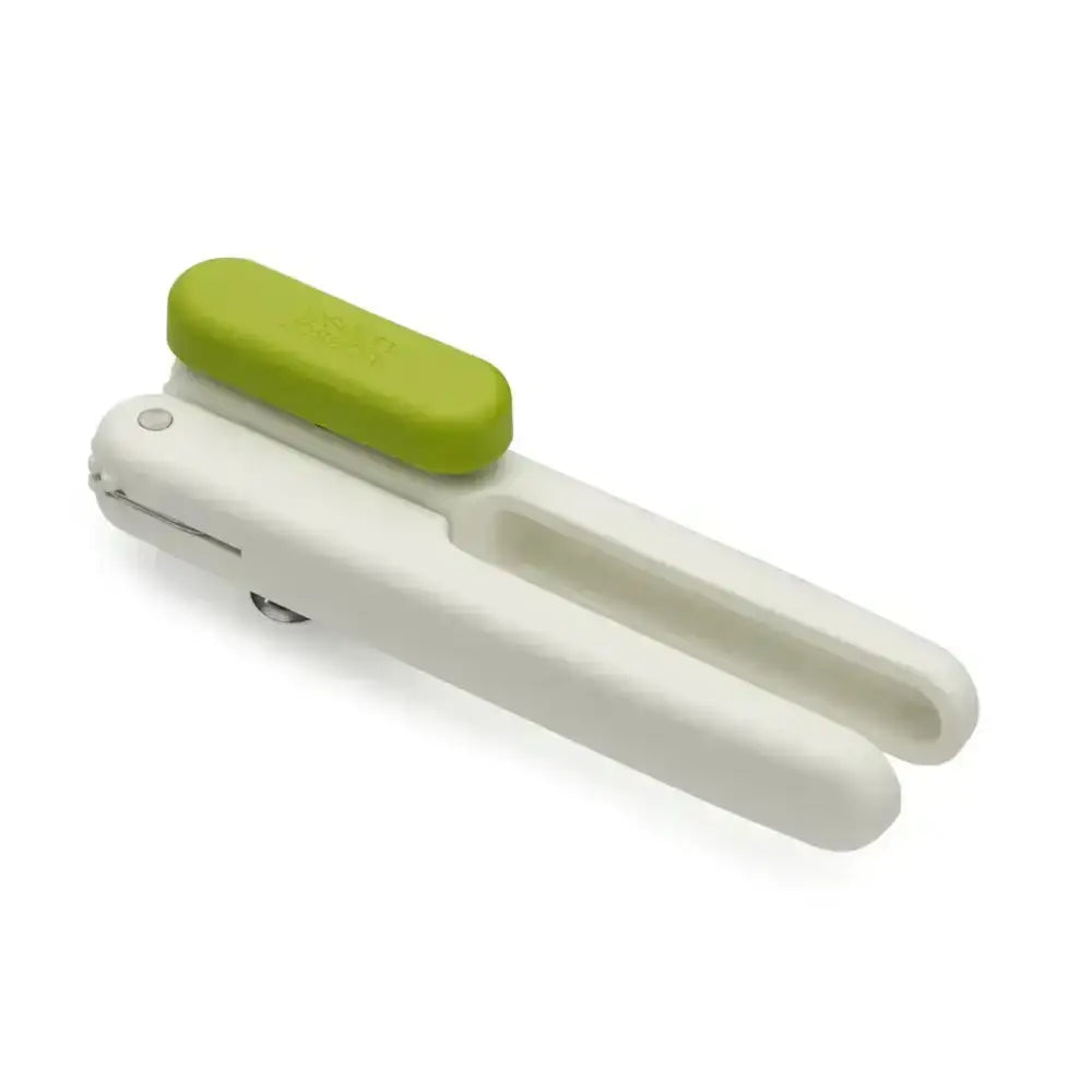 White kitchen tool with a green handle on a white background