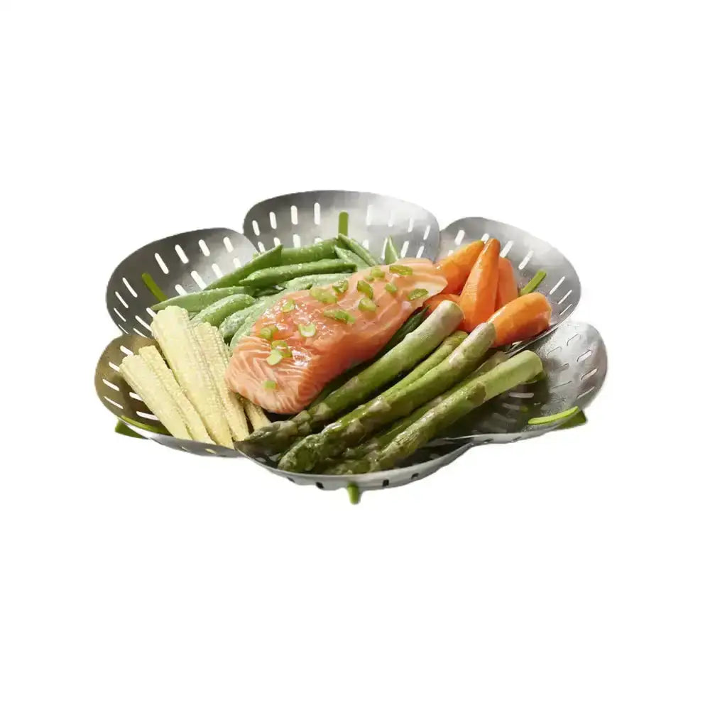 Salmon fillet with vegetables in a metal steamer basket on a white background