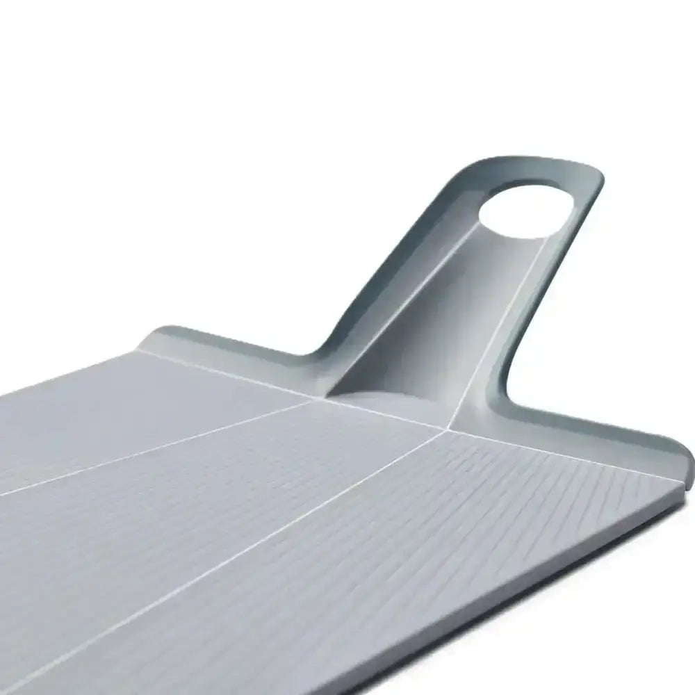 Gray plastic cutting board with handle on a white background