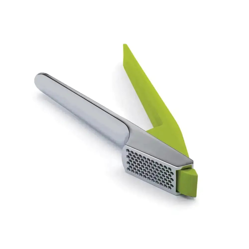 Garlic press with green handle on a white background