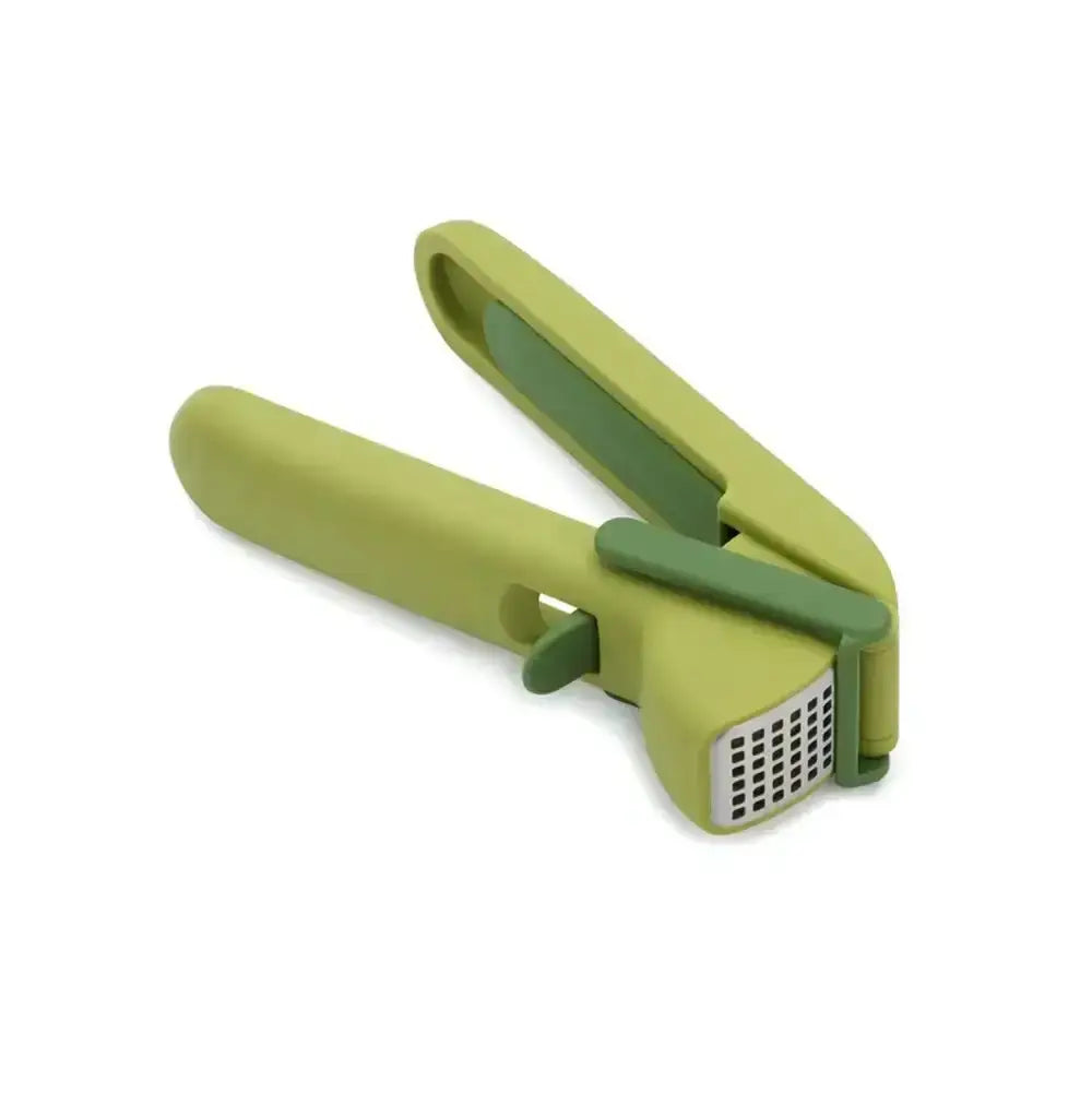 Green garlic press on a white background