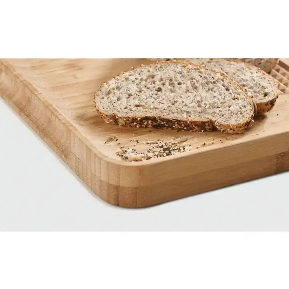 Two slices of bread on a wooden cutting board with a white background
