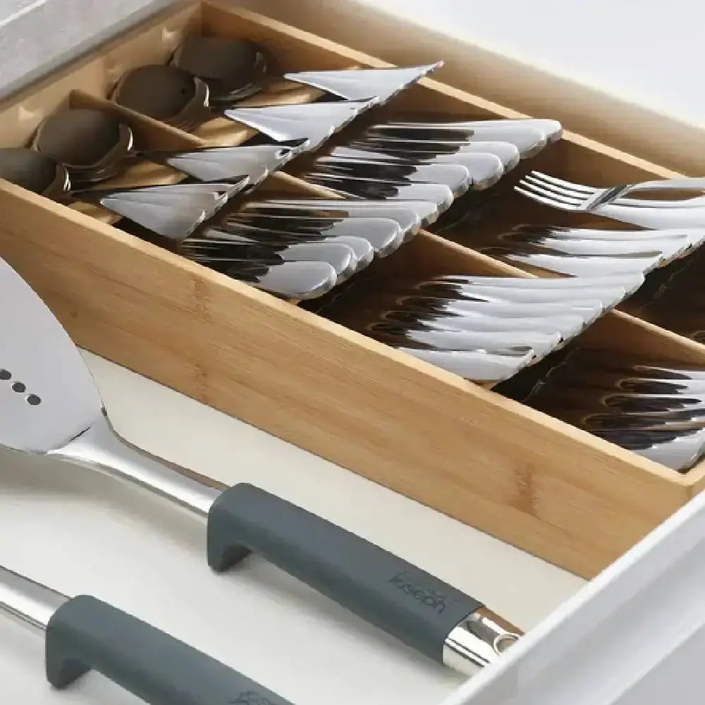 Wooden utensil organizer with cutlery in a kitchen drawer