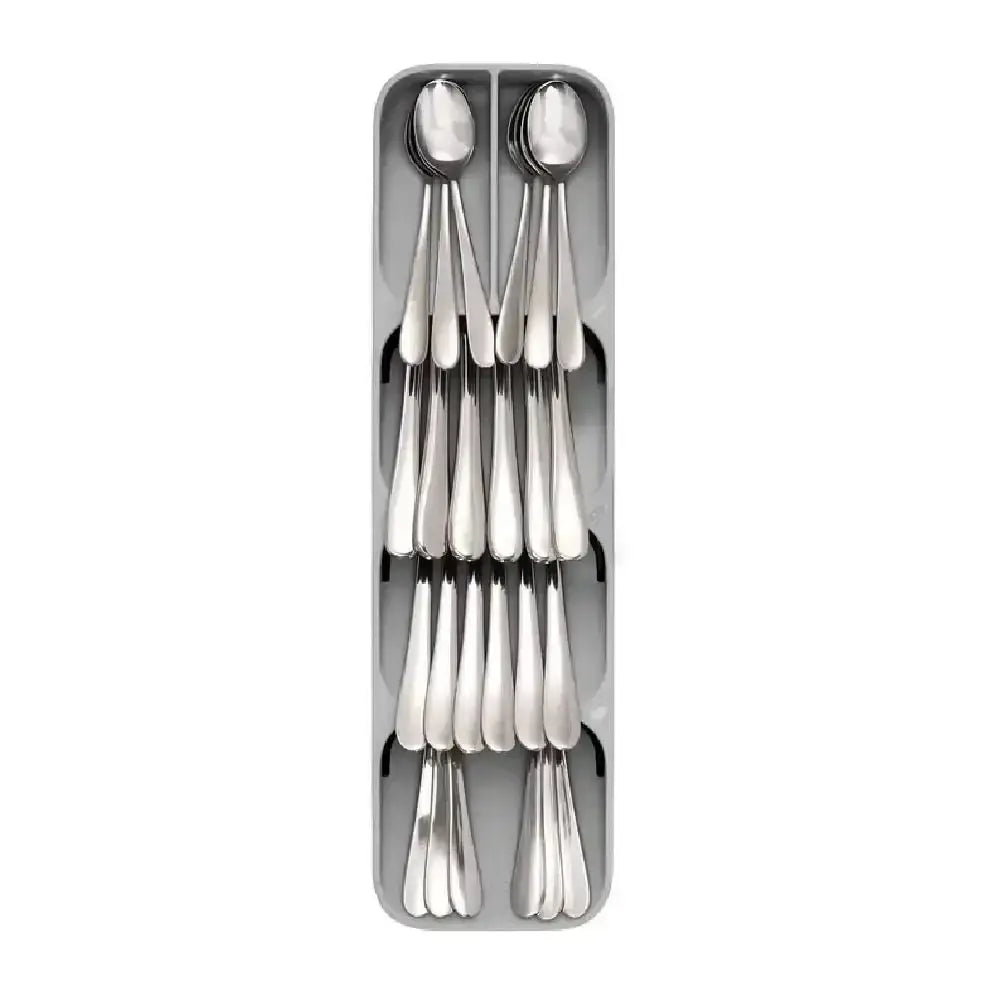 Set of silver spoons in a metallic holder on a white background