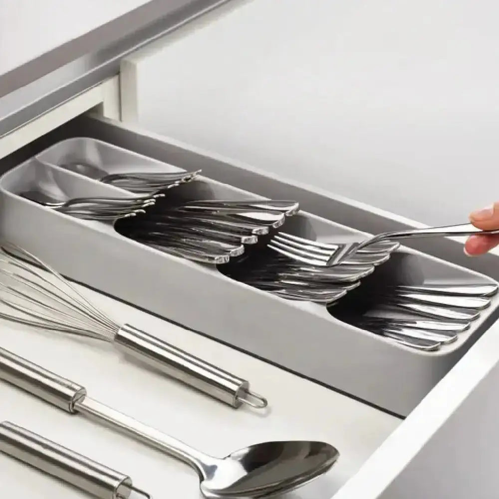 Silverware organizer in a kitchen drawer with forks and spoons.
