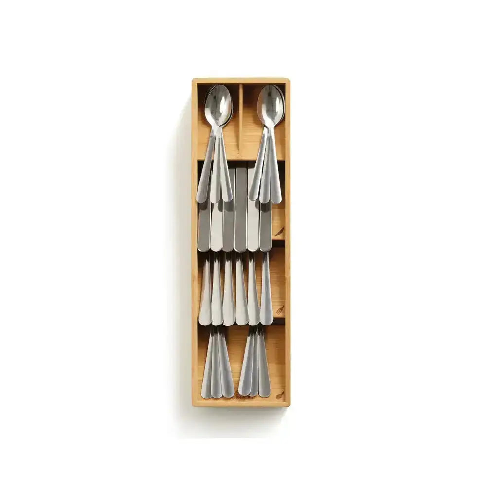 Set of four silver spoons in a wooden box on a white background