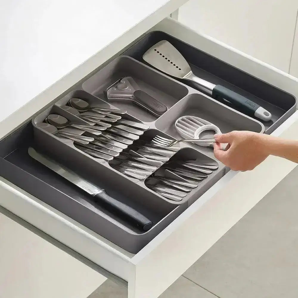 Gray cutlery organizer with utensils in a kitchen drawer