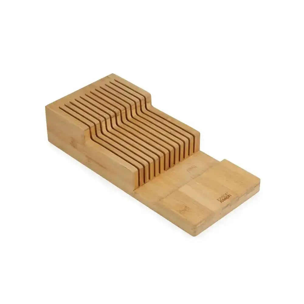 Wooden knife block with multiple slots on a white background