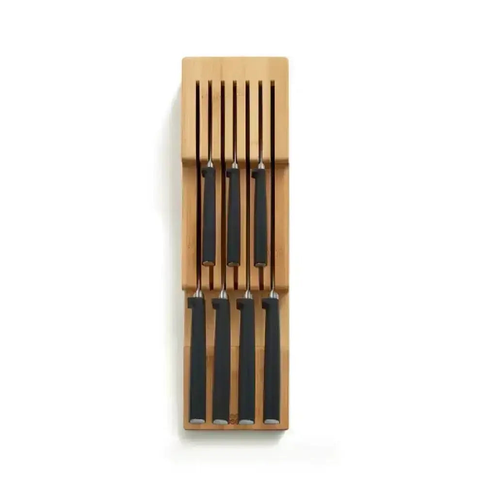 Set of knives with black blades and wooden handles in a wooden holder on a white background
