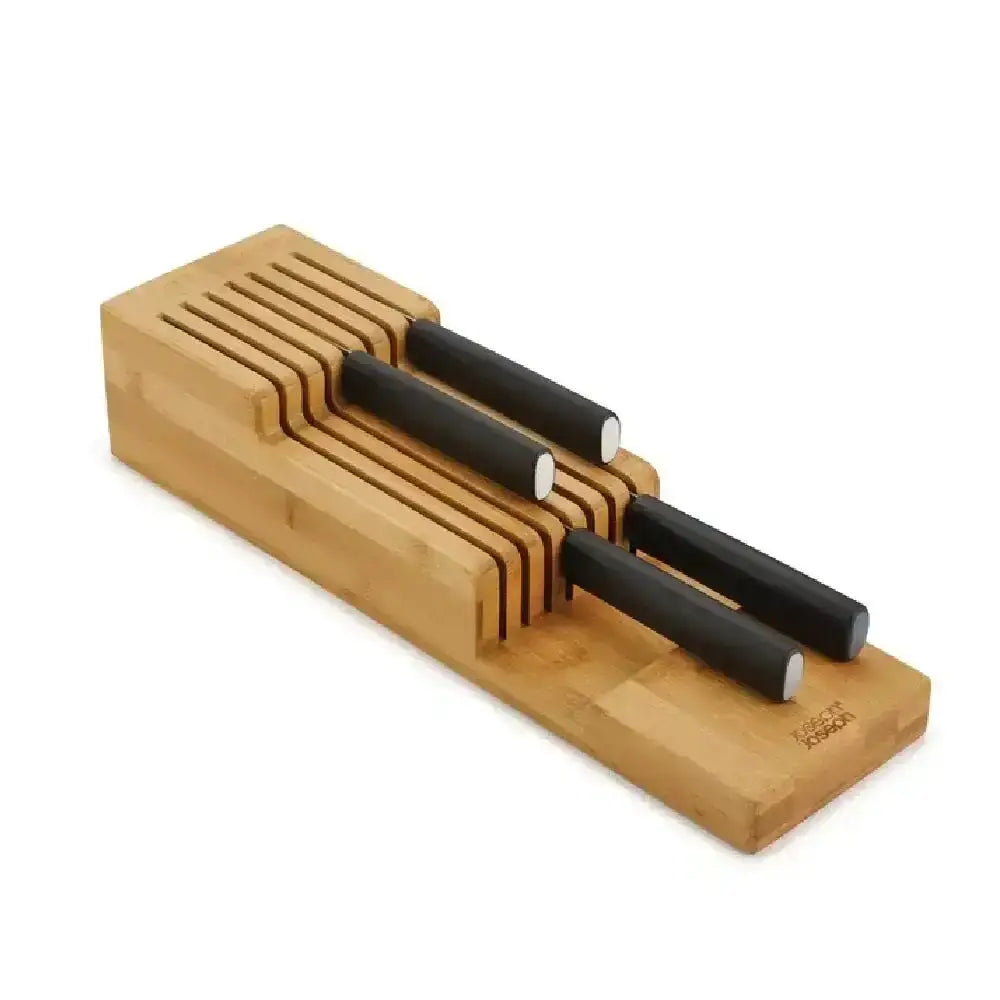 Wooden knife block with black knives on a white background