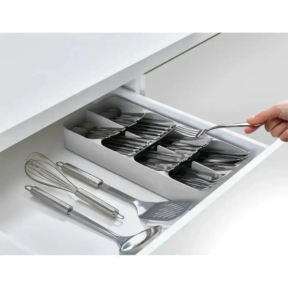 Kitchen drawer with utensil organizer and hand reaching for a fork