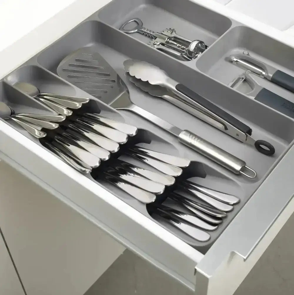 Set of silver cutlery and utensils in a gray organizer
