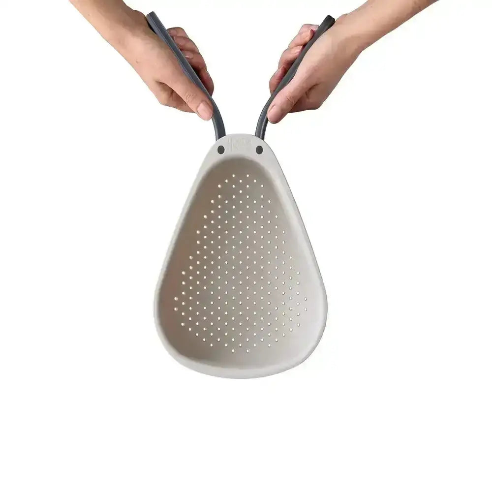 Gray colander with handles held by two hands on a white background