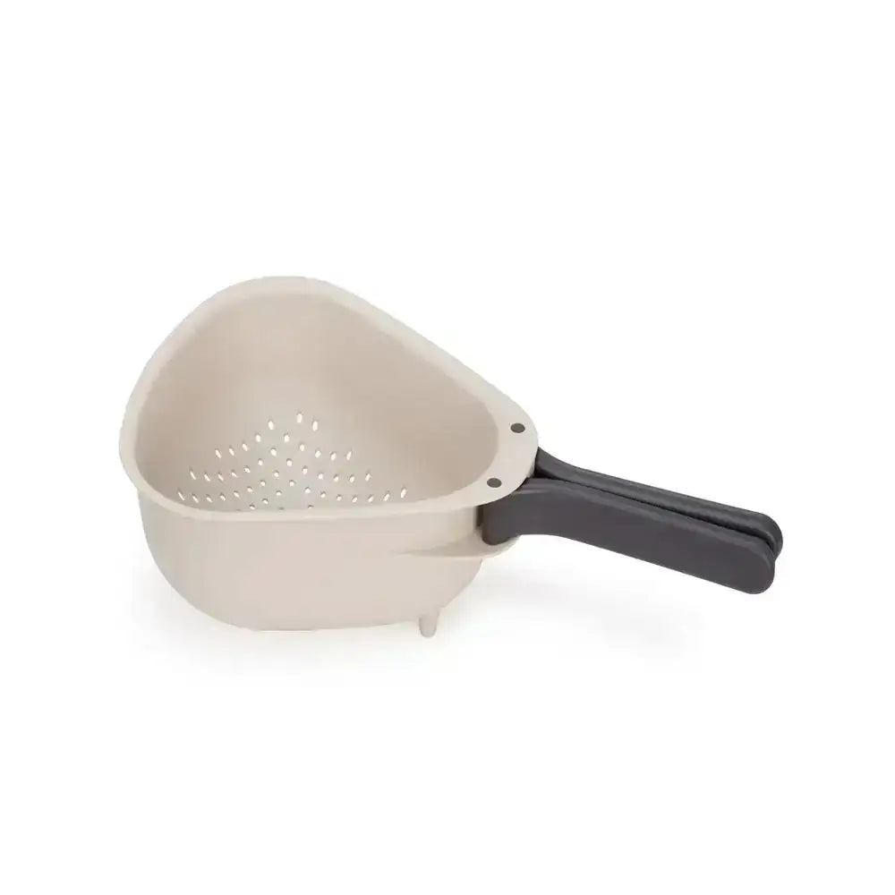 Beige colander with a black handle on a white background