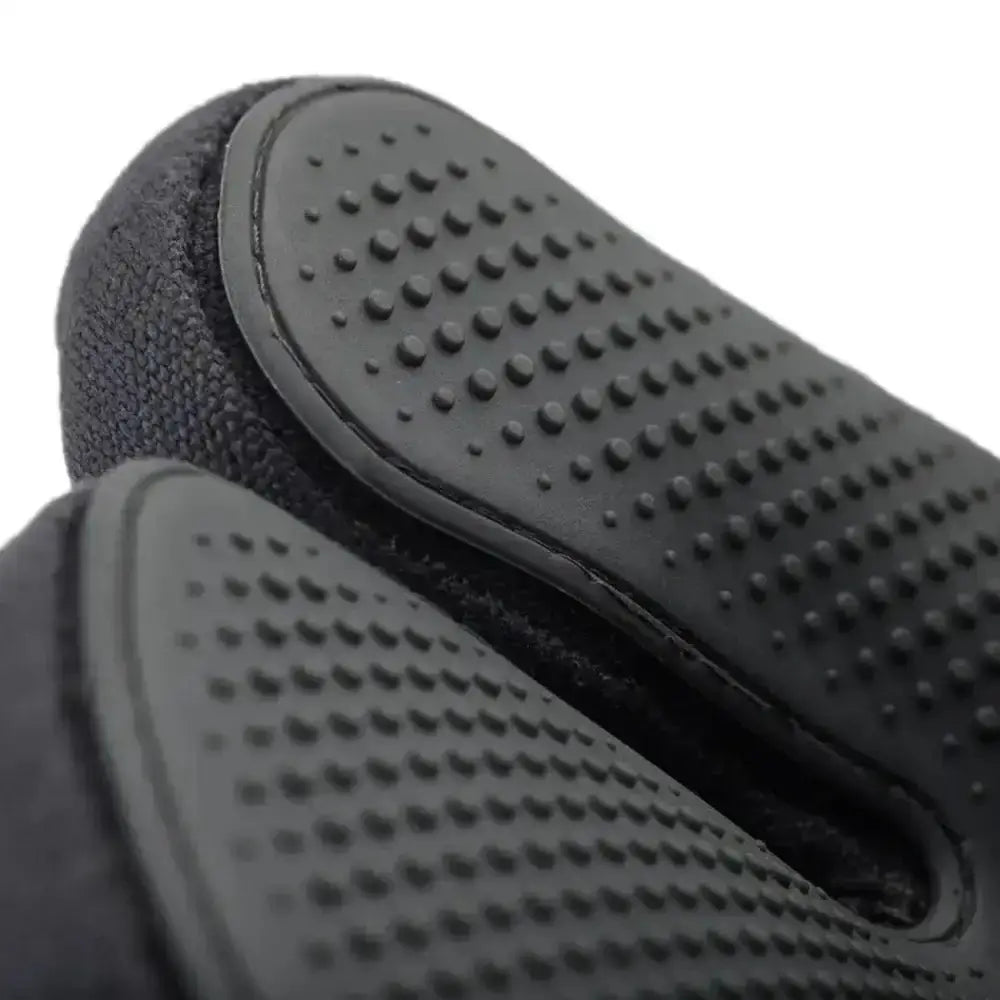 Close-up of black textured gloves on a white background