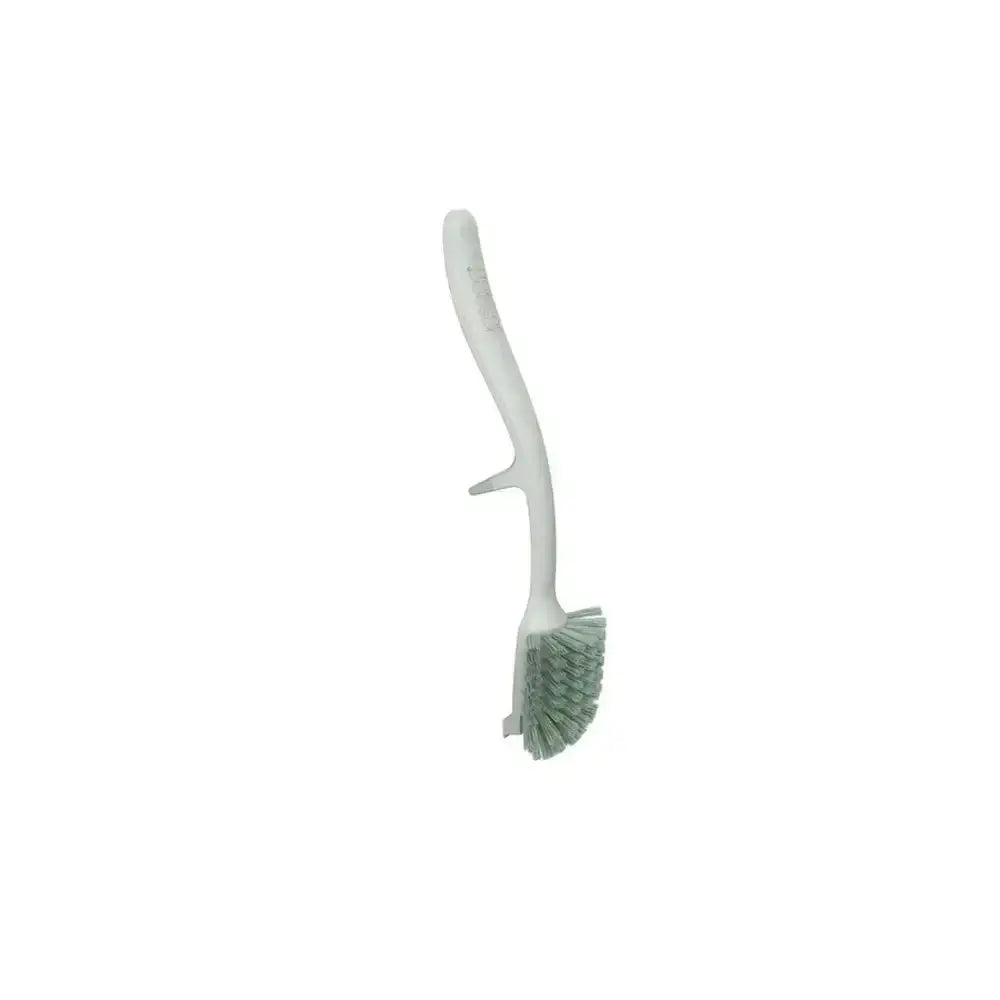 White dish brush with green bristles on a white background