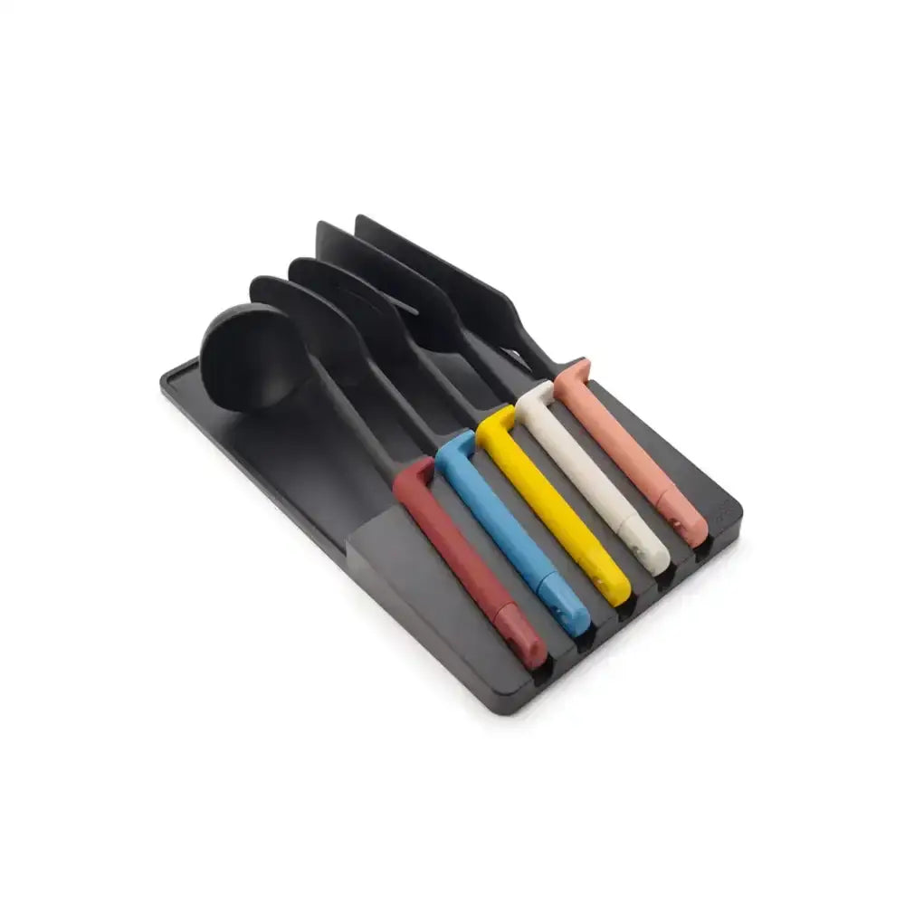 Set of colorful spoons in a black holder on a white background
