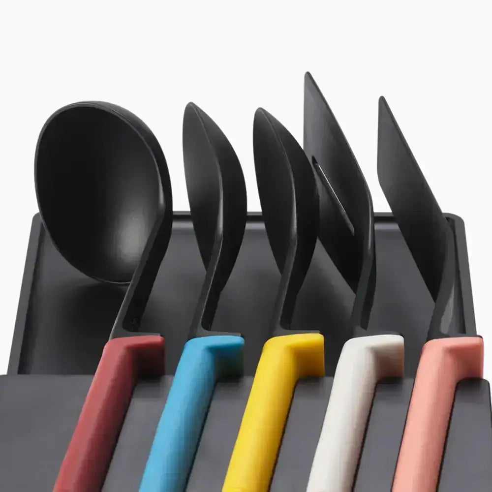Set of black cutlery with colorful handles on a white background