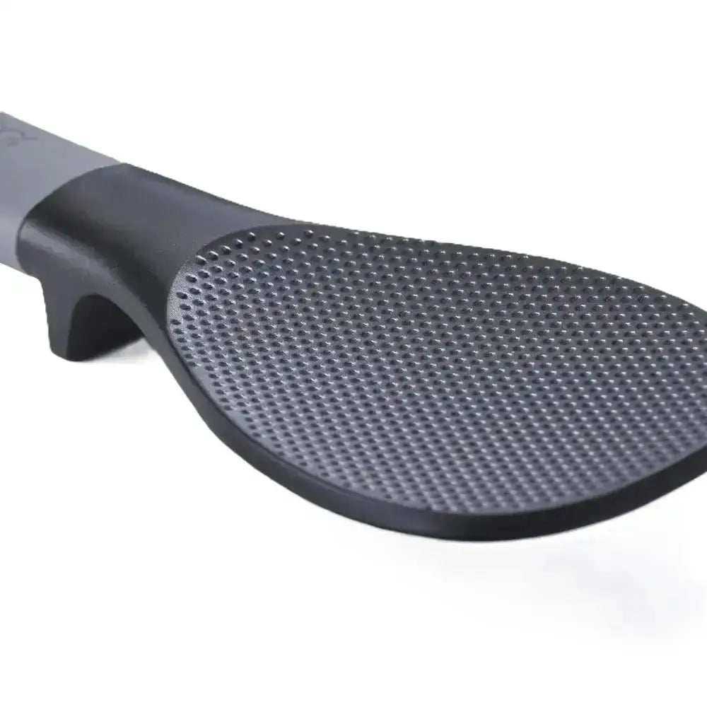 Black kitchen spatula with textured surface on a white background