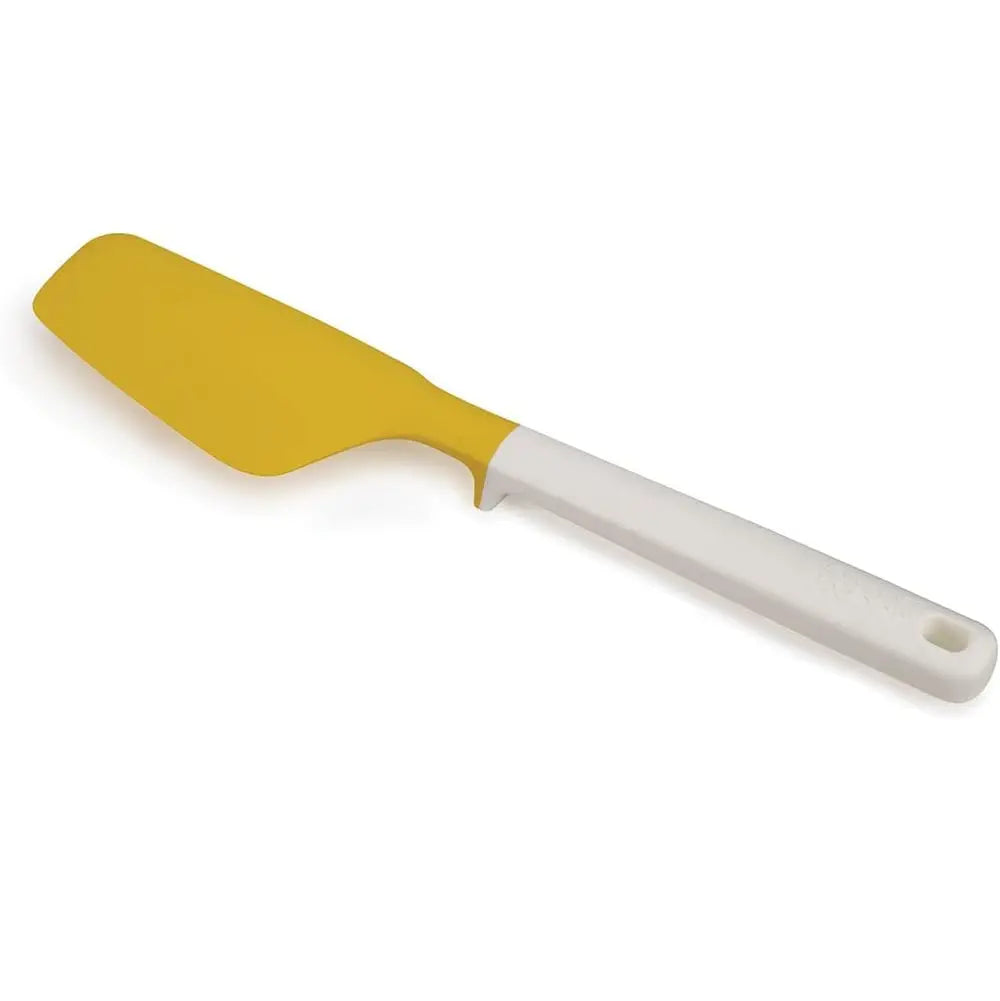 Yellow spatula with a white handle on a white background
