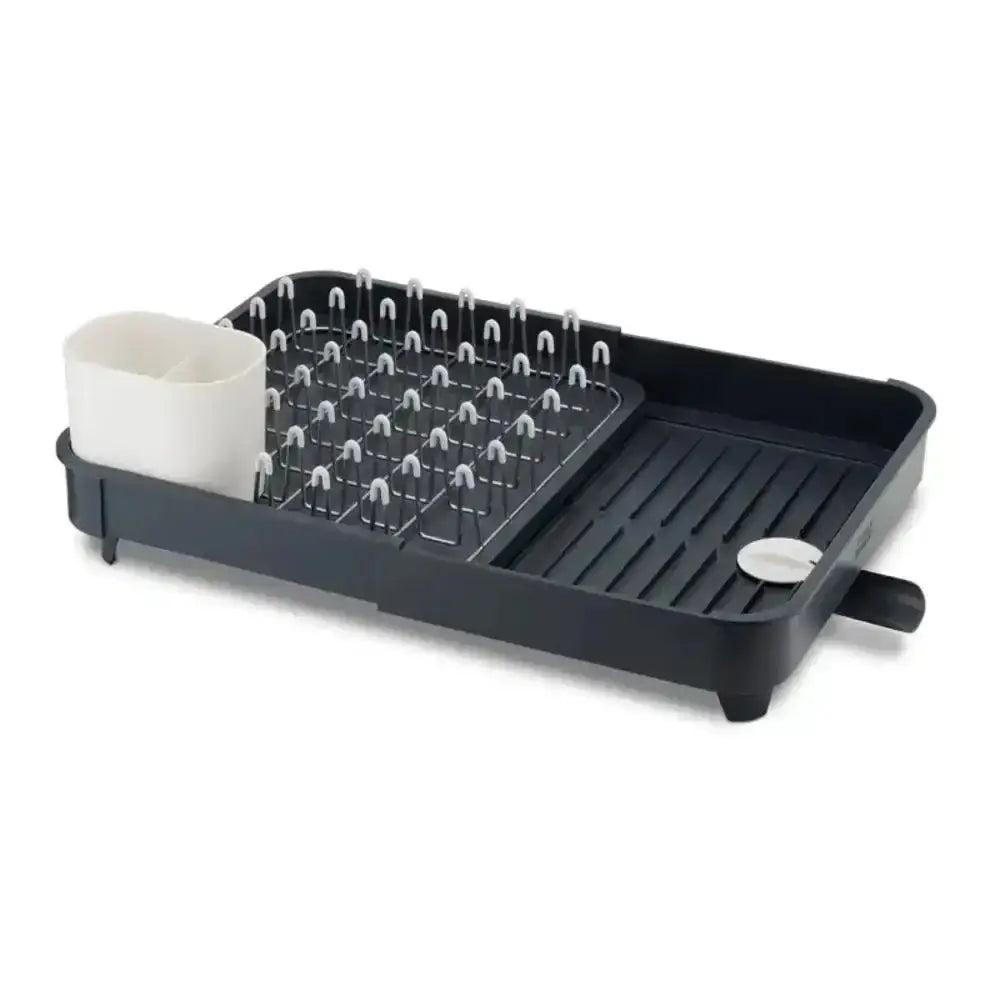 Black dish drying rack with compartments on a white background