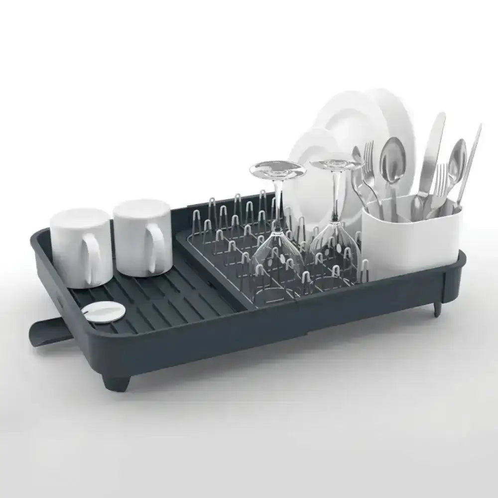 Dish drying rack with mugs, glasses, and cutlery on a white background