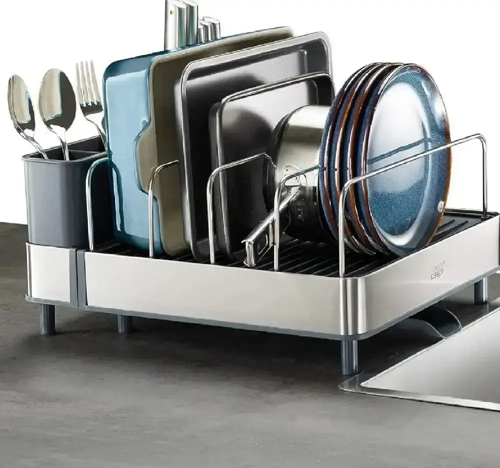 Dish rack with plates, bowls, and utensils on a kitchen counter.
