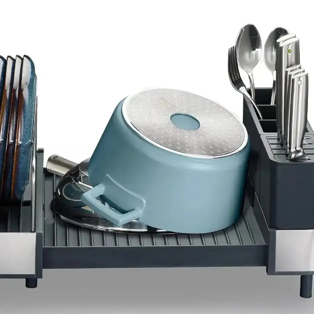 Blue pot with a lid in a kitchen dish rack with utensils