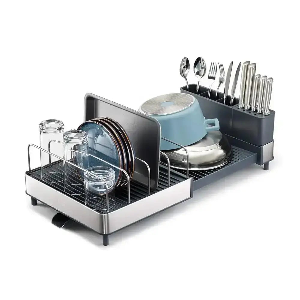 Dish drying rack with dishes and utensils on a white background