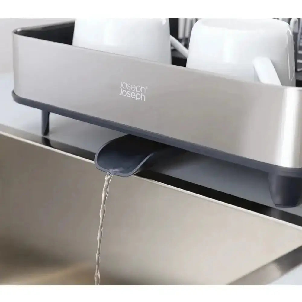 Joseph Joseph kitchen sink strainer with water flowing into a sink