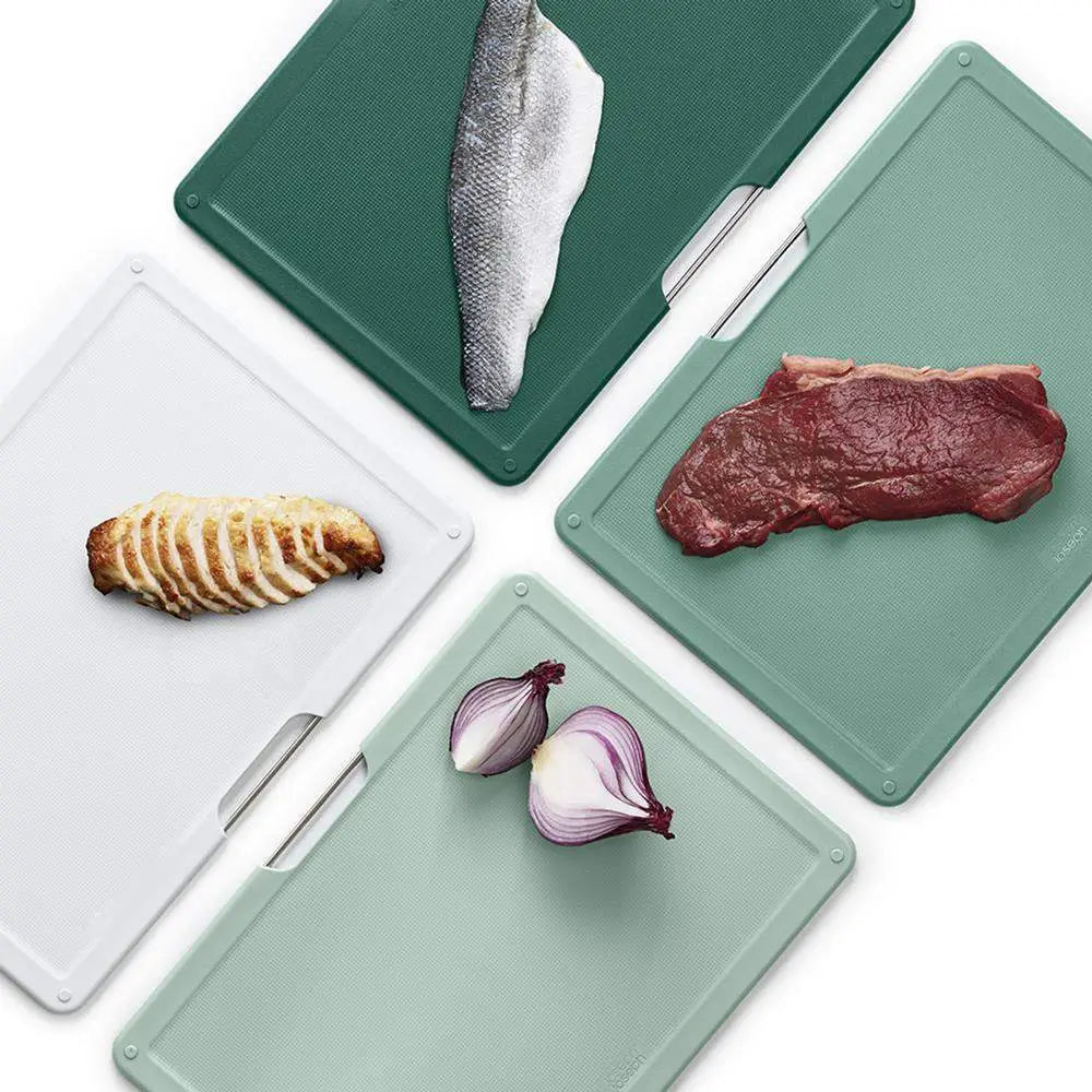 Set of cutting boards with various food items on a white background