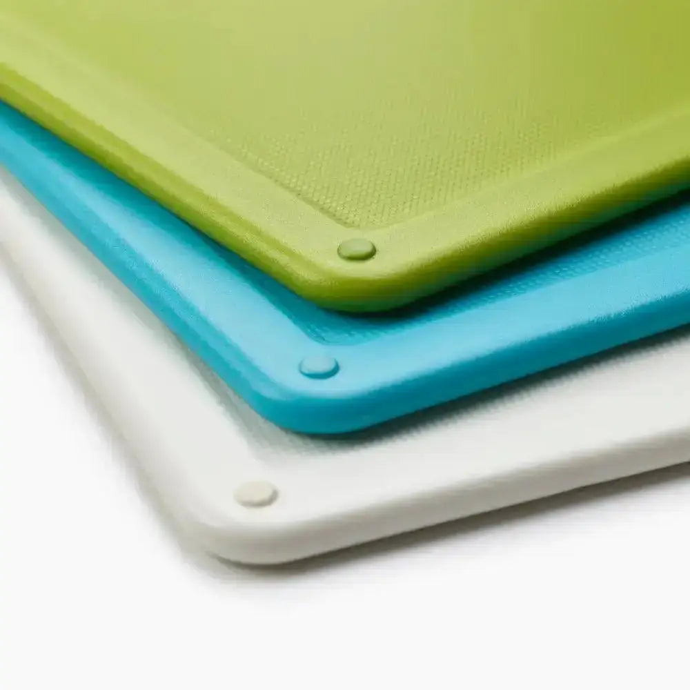 Stacked joseph joseph folio slim 3-piece under-shelf cutting boards in lime green bright blue and off-white plastic