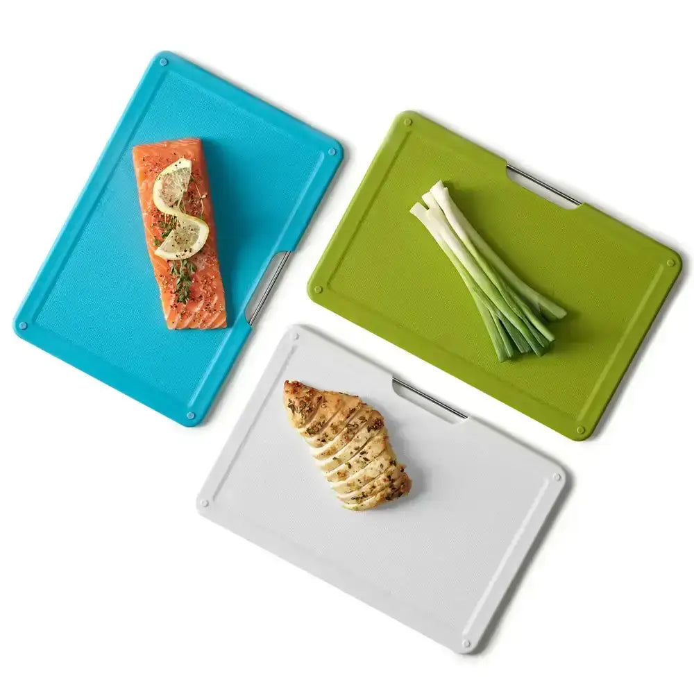 Three cutting boards with food items on a white background