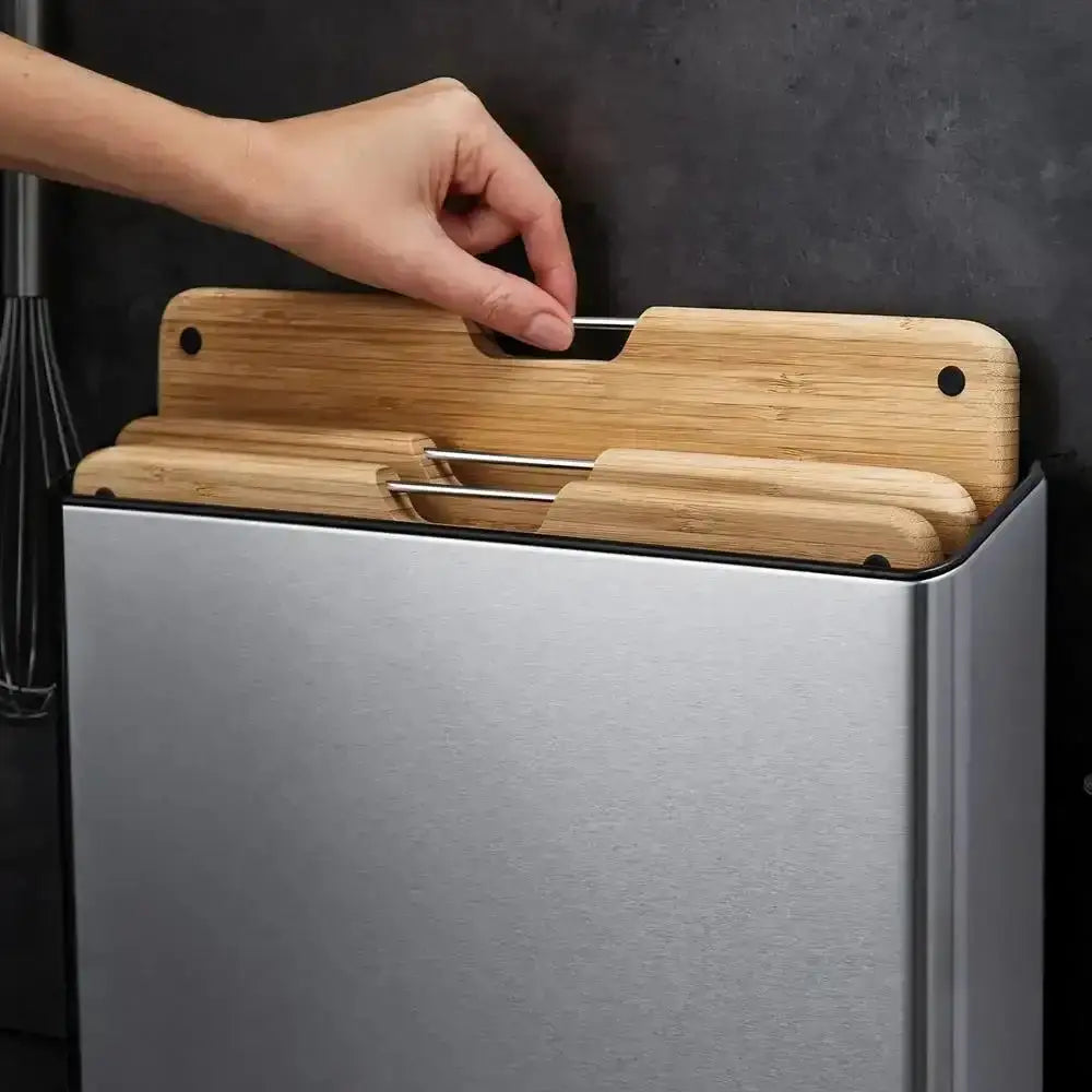 Hand pulling out a cutting board from a set of three.