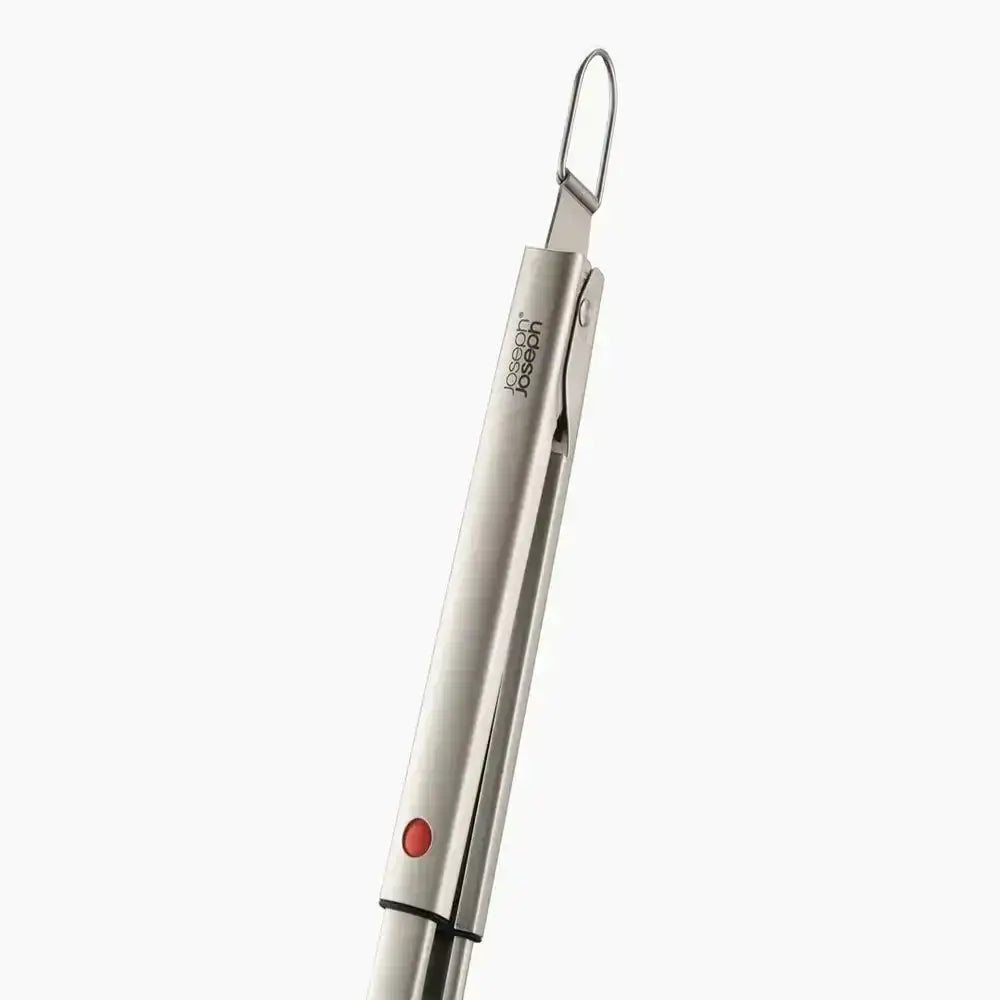 Metallic utensil with a red accent on a white background