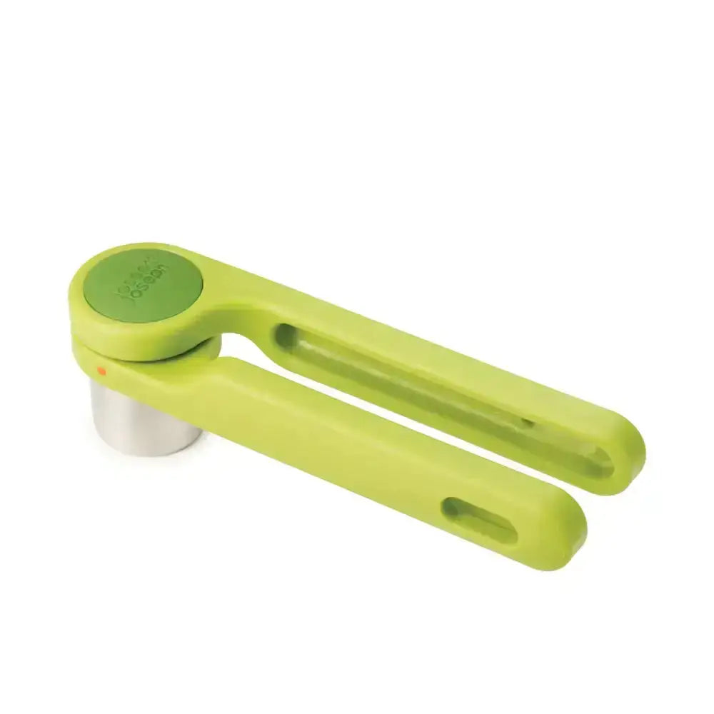 Green garlic press on a white background